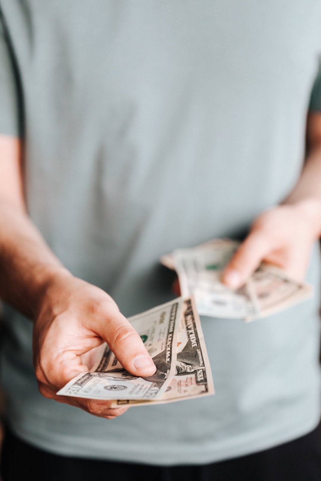 Free Crop man paying with American dollars Stock Photo